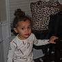 Bronx is registered to the contest to win money with this photo: child, pajamas, candy_cane_pattern, table, hand, leopard_print_bag, camera_bag, window_blinds, wainscoting, indoor, furniture, person, face, expression, curly_hair, brown_eyes, home, paper_towel, dark_wood, floor