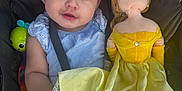 Miyah is registered to the contest to win money with this photo: baby, blue_headband, child, childhood, clothing, cute, doll, face, hair, hand, indoor, infant, person, portrait, seatbelt, smile, soft_toy, stroller, toy, yellow_dress