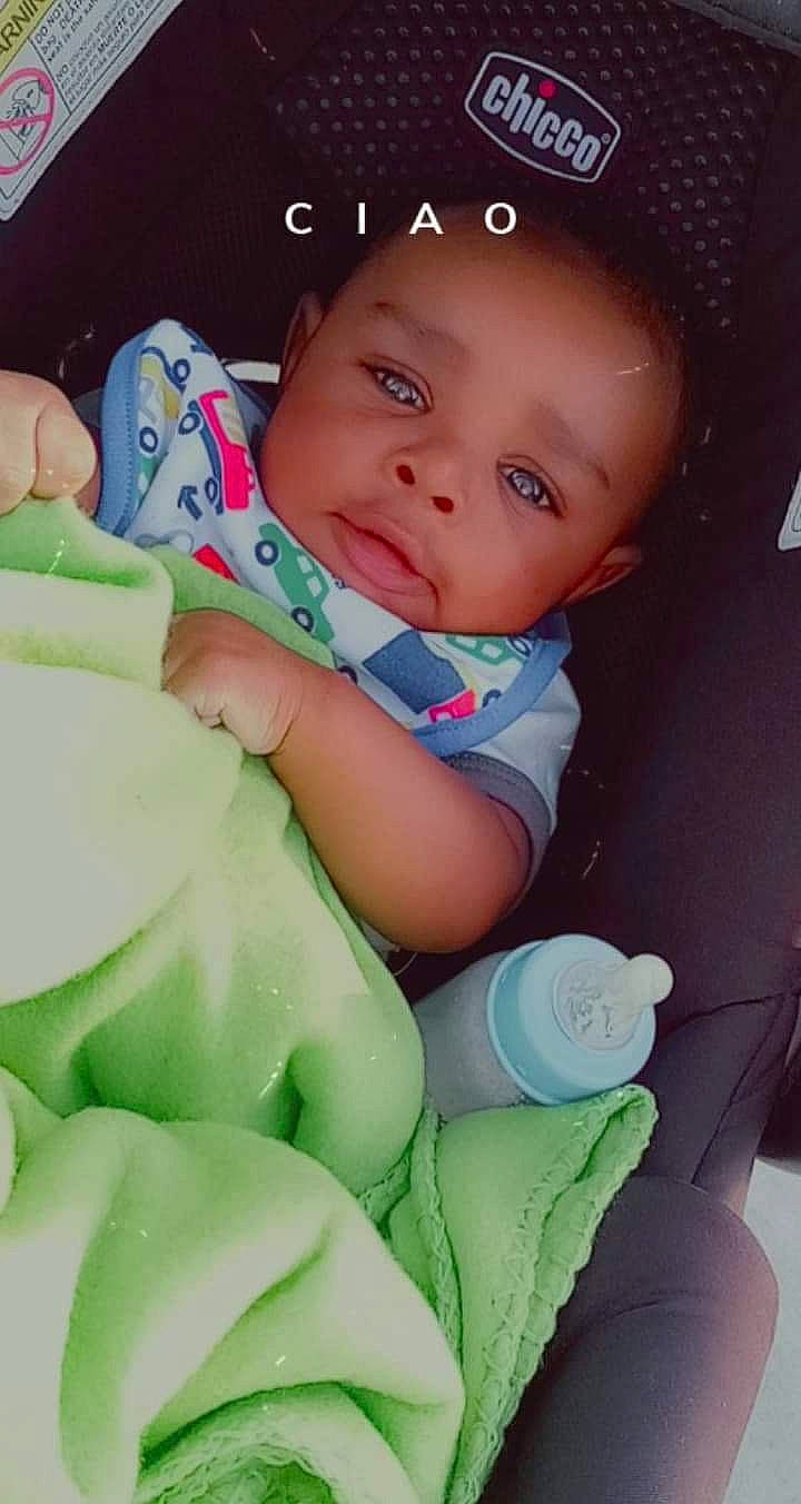 Jojo is registered to the contest to win money with this photo: baby, baby_products, baby_safety, baby_sleeping, baby_toddler_clothing, cap, cheek, child, comfort, fashion_accessory, finger, green, happy, linens, nail, organ, person, sitting, skin, smile