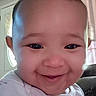 Octavia is registered to the contest to win money with this photo: baby, smiling, face, indoor, child, portrait, cute, happy, infant, person, head, clothing, light, window, curtain, skin, expression, toddler, closeup, young_child
