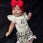 Kattaleya joined the competition — help win amazing prizes! baby, infant, red_bow, headband, leopard_print, shorts, white_shirt, cute, portrait, child, young, socks, lying_down, dark_background, looking_away, small_hand, soft_lighting, adorable, fashionable, newborn