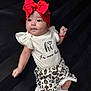 baby, infant, red_bow, headband, leopard_print, shorts, white_shirt, cute, portrait, child, young, socks, lying_down, dark_background, looking_away, small_hand, soft_lighting, adorable, fashionable, newborn