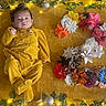 baby, blanket, celebration, colorful, cozy, cute, decor, fairy_lights, festive, floral_arrangement, flowers, indoor, infant, ivy, lying_down, mustard_yellow, number_two, onesie, portrait, soft_texture