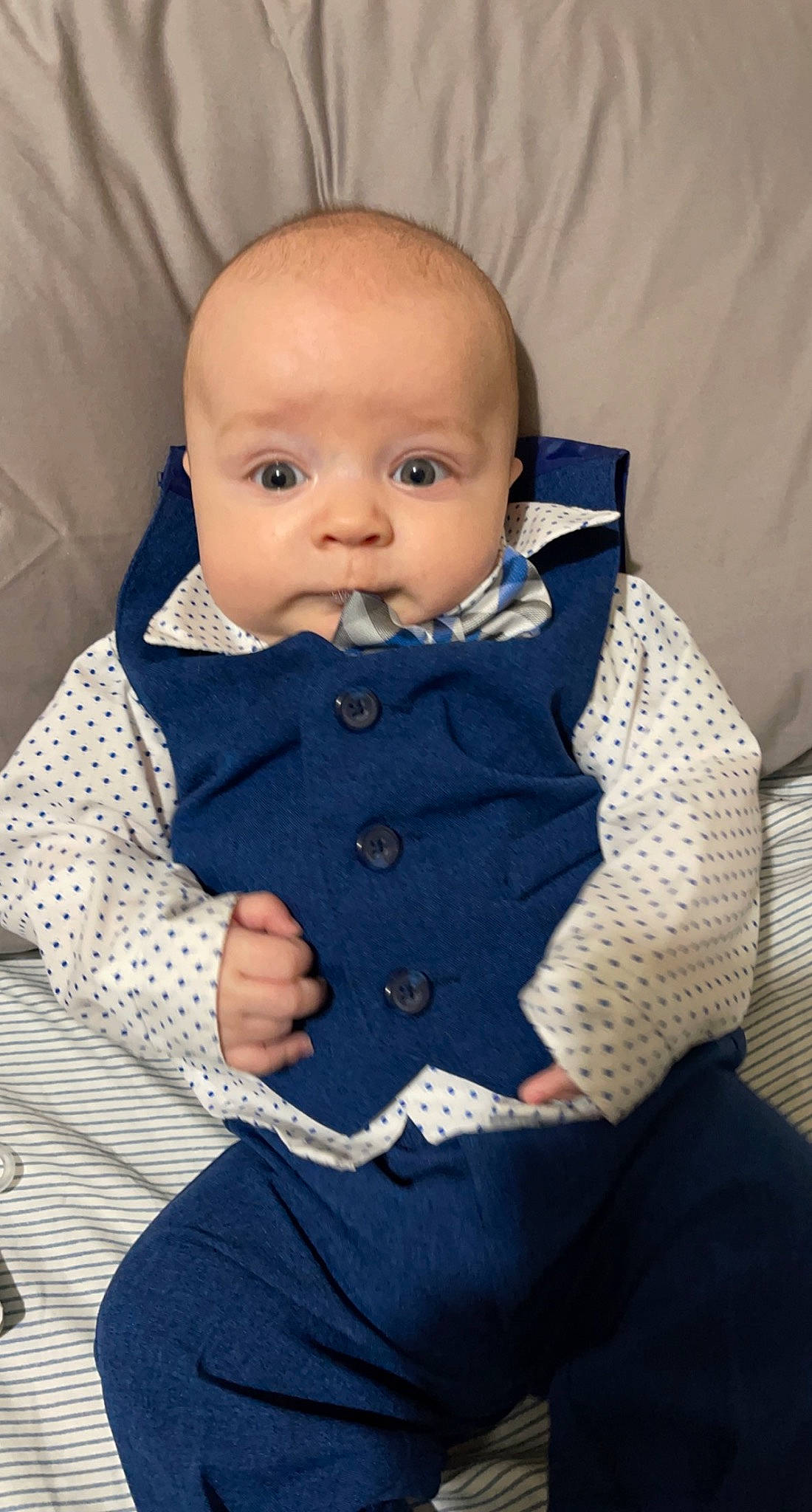 Baylor is registered to the contest to win money with this photo: baby, baby_products, baby_toddler_clothing, button, cheek, child, collar, comfort, electric_blue, eye, iris, linens, outerwear, pattern, person, sitting, skin, sleeve, textile, toddler