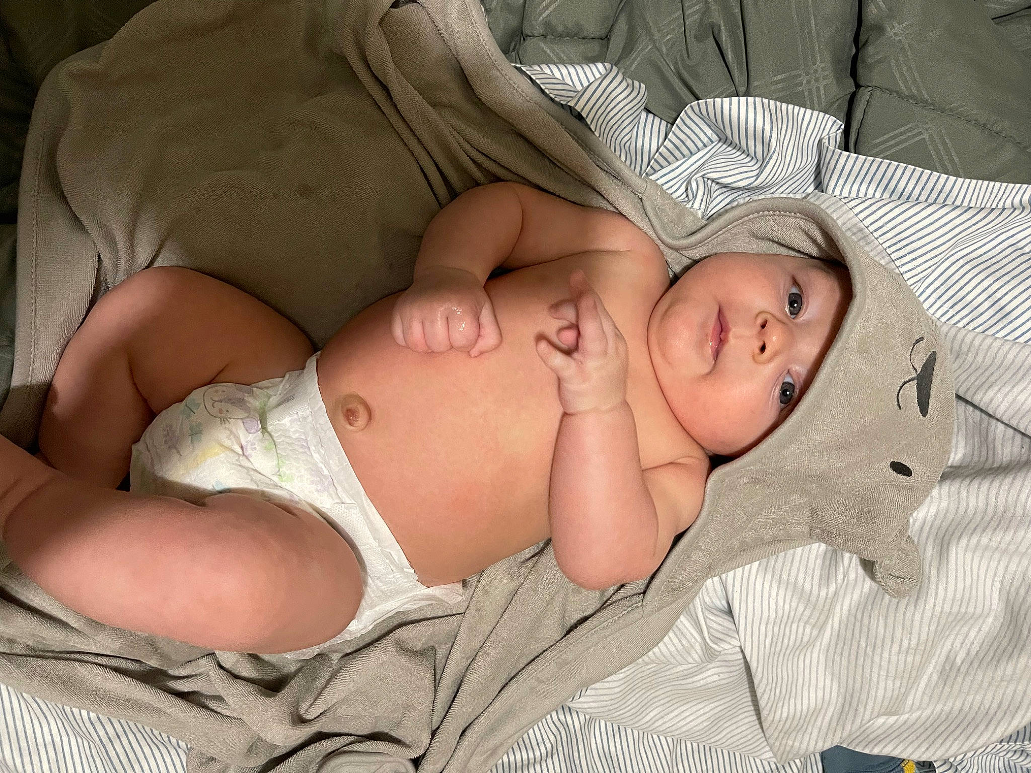 Baylor is registered to the contest to win money with this photo: abdomen, baby, baby_toddler_clothing, cheek, chest, child, comfort, eye, face, grass, head, headwear, human_body, pattern, person, sitting, skin, sleep, stomach, thigh