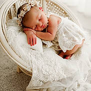Faten Hussein participe au concours pour gagner de l'argent avec cette photo : baby, chair, cozy, cushion, cute, decor, delicate, elegant, flower_headband, indoors, infant, lace, newborn, peaceful, portrait, resting, sleeping, soft_texture, tulle, white