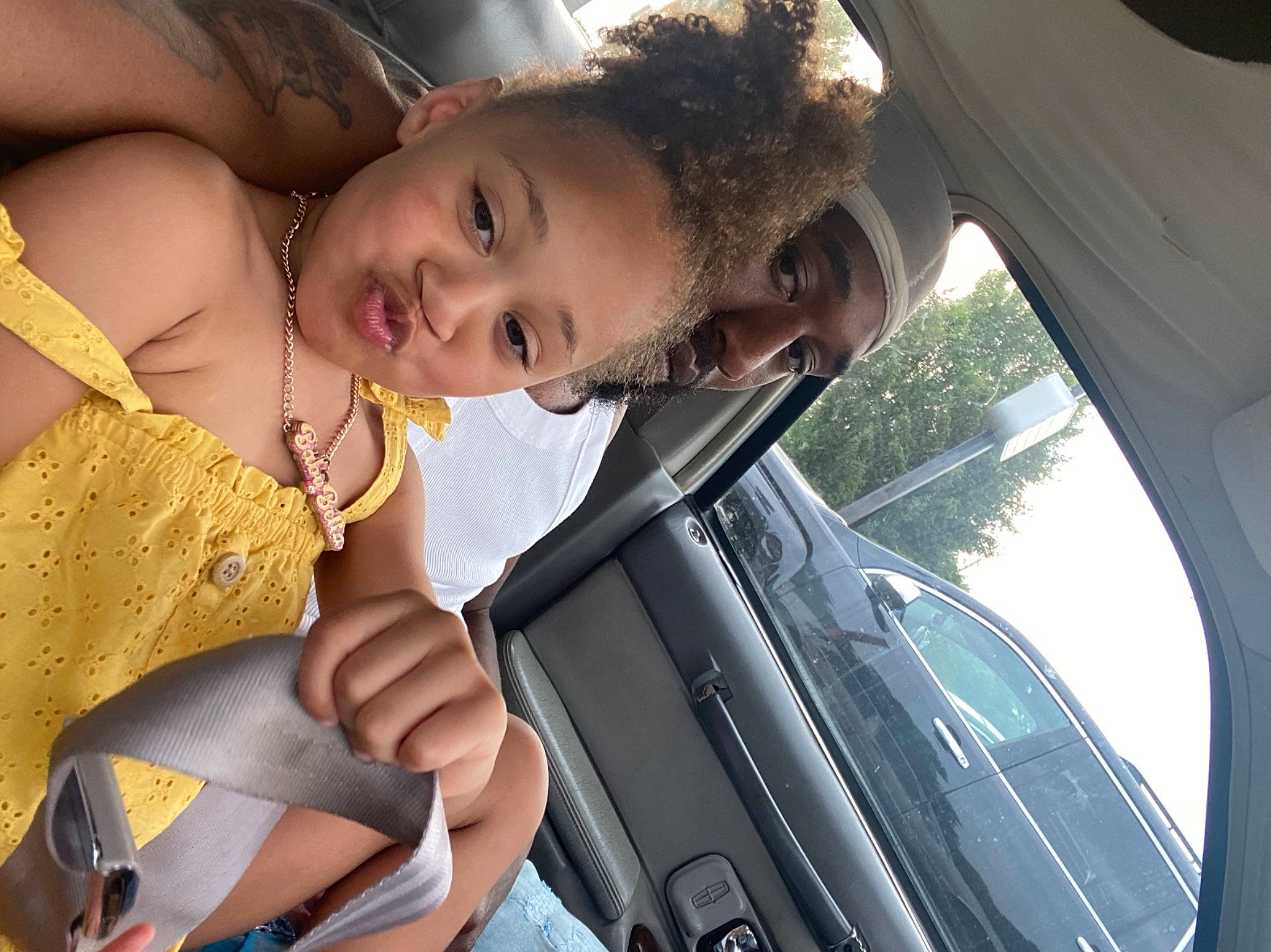 Alyssia is registered to the contest to win money with this photo: automotive_exterior, automotive_lighting, black_hair, car, door, dress, eye, facial_expression, fun, hair, happy, head, motor_vehicle, mouth, person, skin, smile, toddler, vehicle, vehicle_door