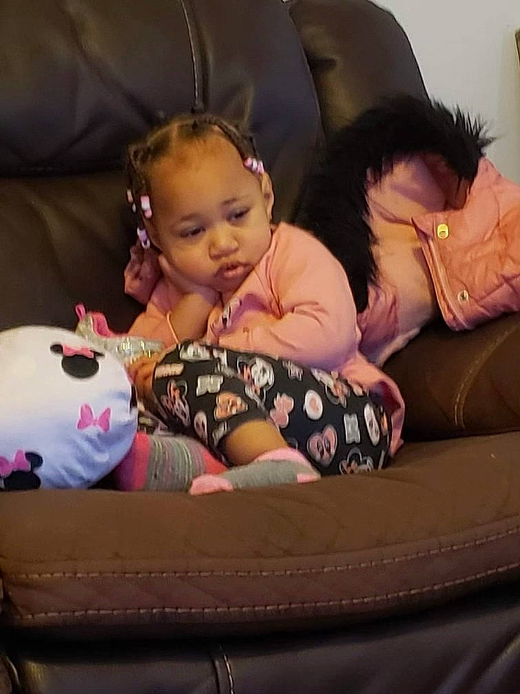 Alyssia joined the competition — help win amazing prizes! baby, baby_sleeping, baby_toddler_clothing, bed, bedding, car_seat, child, comfort, couch, fun, happy, lap, linens, mammal, person, pink, room, sitting, textile, thigh