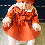 Bethany is registered to the contest to win money with this photo: baby, baseballcap, blanket, bonnet, cap, clothing, coat, costume, dress, face, hat, head, hood, jacket, pants, person, photography, portrait, sitting, sleeve