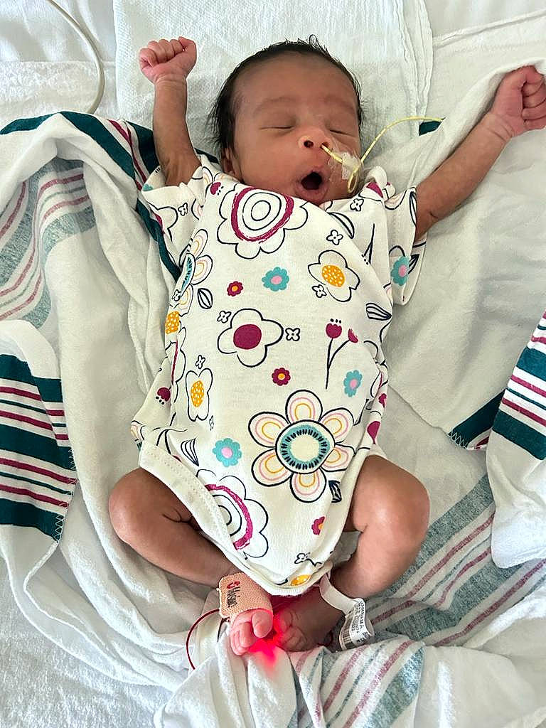 Zayan is registered to the contest to win money with this photo: abdomen, baby, baby_products, baby_safety, baby_sleeping, baby_toddler_clothing, bedding, cheek, child, comfort, gesture, happy, linens, neck, pattern, person, skin, sleeve, t_shirt, thumb