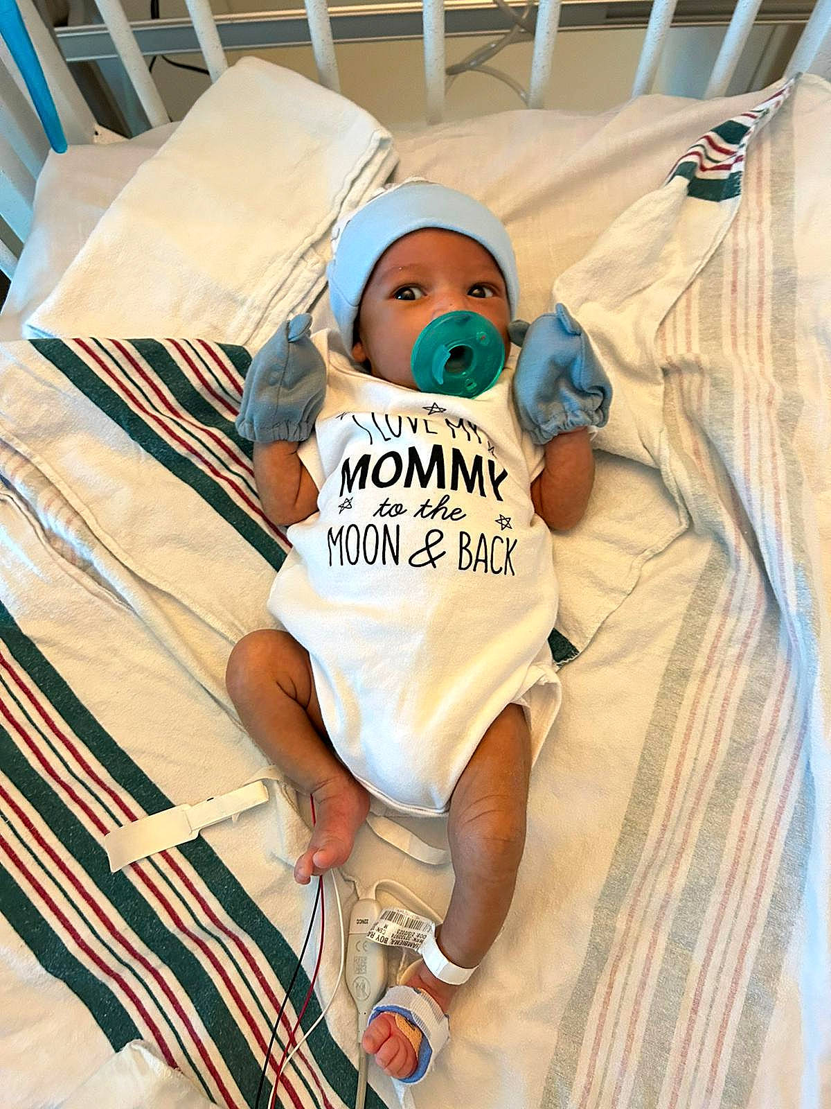 Zayan is registered to the contest to win money with this photo: baby, baby_safety, baby_toddler_clothing, child, comfort, costume, eyewear, flooring, fun, happy, hat, headwear, human_leg, leisure, linens, person, sandal, sitting, sleeve, t_shirt