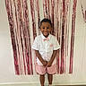 Selyan participe au concours pour gagner de l'argent avec cette photo : child, boy, smile, happy, standing, indoor, party, decoration, fringe_curtain, pink, white_shirt, bow_tie, shorts, sneakers, wooden_floor, wall, fashion, portrait, celebration, cute