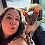Dexter is registered to the contest to win money with this photo: armrest, cactus, cat, closeup, couch, earrings, expression, feline, hairless_cat, indoor, natural_light, person, pet, plant, playful, portrait, skin, sphynx_cat, window, woman