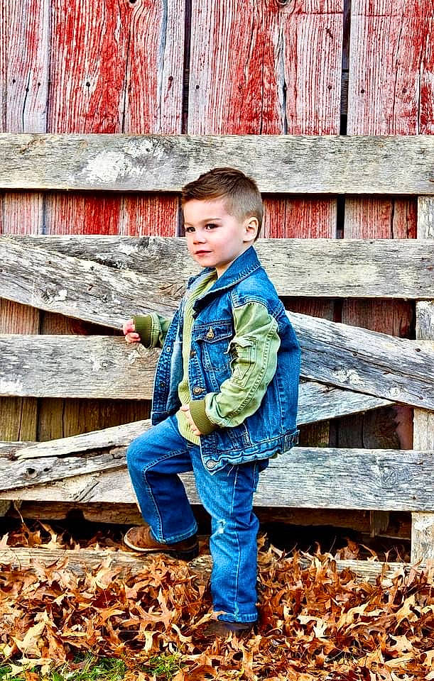 Kolton is registered to the contest to win money with this photo: blond, child, denim, electric_blue, facial_expression, flash_photography, forest, fun, grass, hair, happy, jeans, landscape, leaf, leisure, people_in_nature, person, standing, toddler, tree