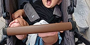 Ahmed participe au concours pour gagner de l'argent avec cette photo : baby, stroller, cap, yawning, toy, urban, pavement, stone_steps, outdoor, child, black_clothing, gray_stroller, foot, hand, seatbelt, wheel, fabric, cute, infant, person