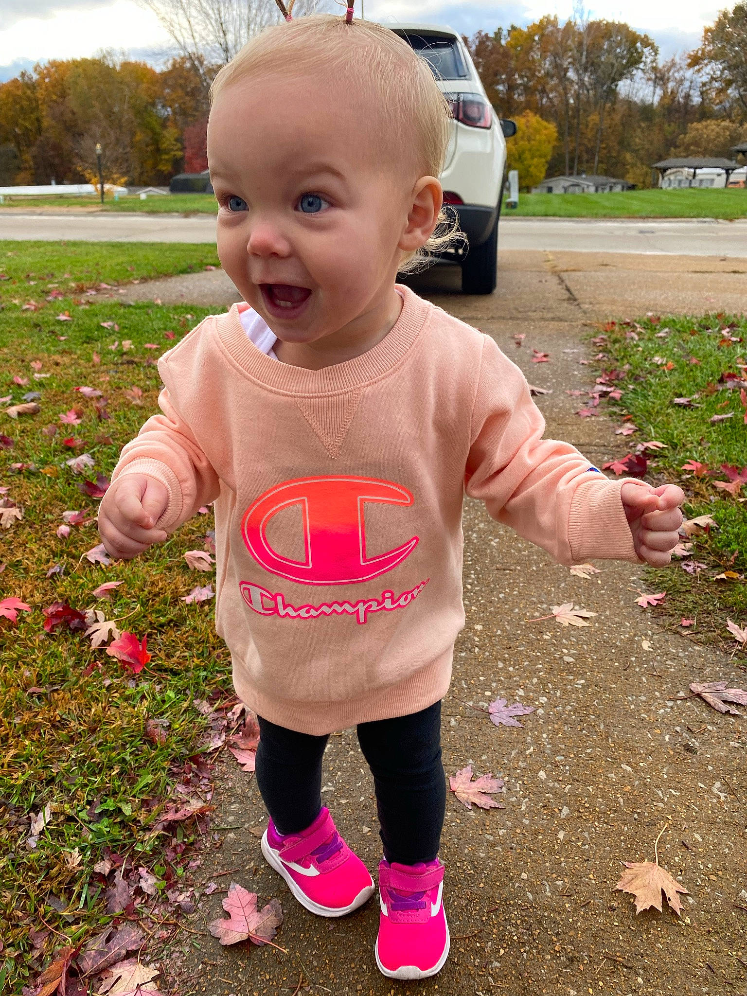 Iliana is registered to the contest to win money with this photo: baby, baby_toddler_clothing, car, child, fun, grass, happy, people_in_nature, person, pink, plant, recreation, sky, sleeve, smile, summer, t_shirt, tire, toddler, tree