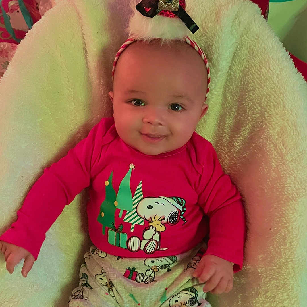 Xavier joined the competition — help win amazing prizes! baby, child, christmas, cushion, cute, decorations, festive, gift_bags, happy, headband, holiday_hat, holiday_season, indoor, pajamas, portrait, red_clothing, seated, smiling, snoopy, soft_texture