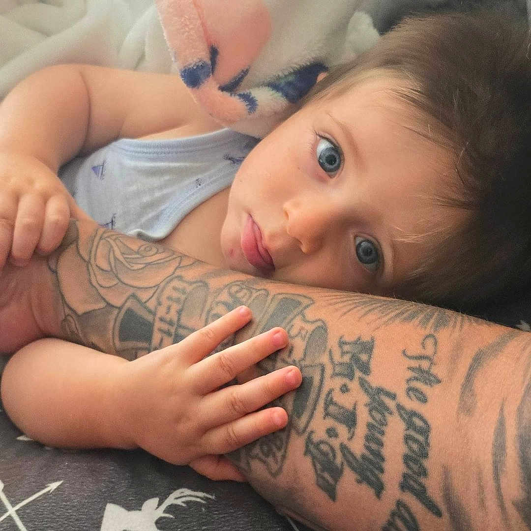 David joined the competition — help win amazing prizes! arm, baby, bodypart, clothing, face, finger, hand, head, hugging, knee, newborn, number, person, photography, portrait, skin, sleeve, symbol, tattoo, thigh