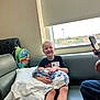 Aspen is registered to the contest to win money with this photo: child, newborn, hospital, blanket, couch, window, backpack, smile, person, indoor, happy, phone, family, baby, pillow, clothing, seat, light, casual, holding