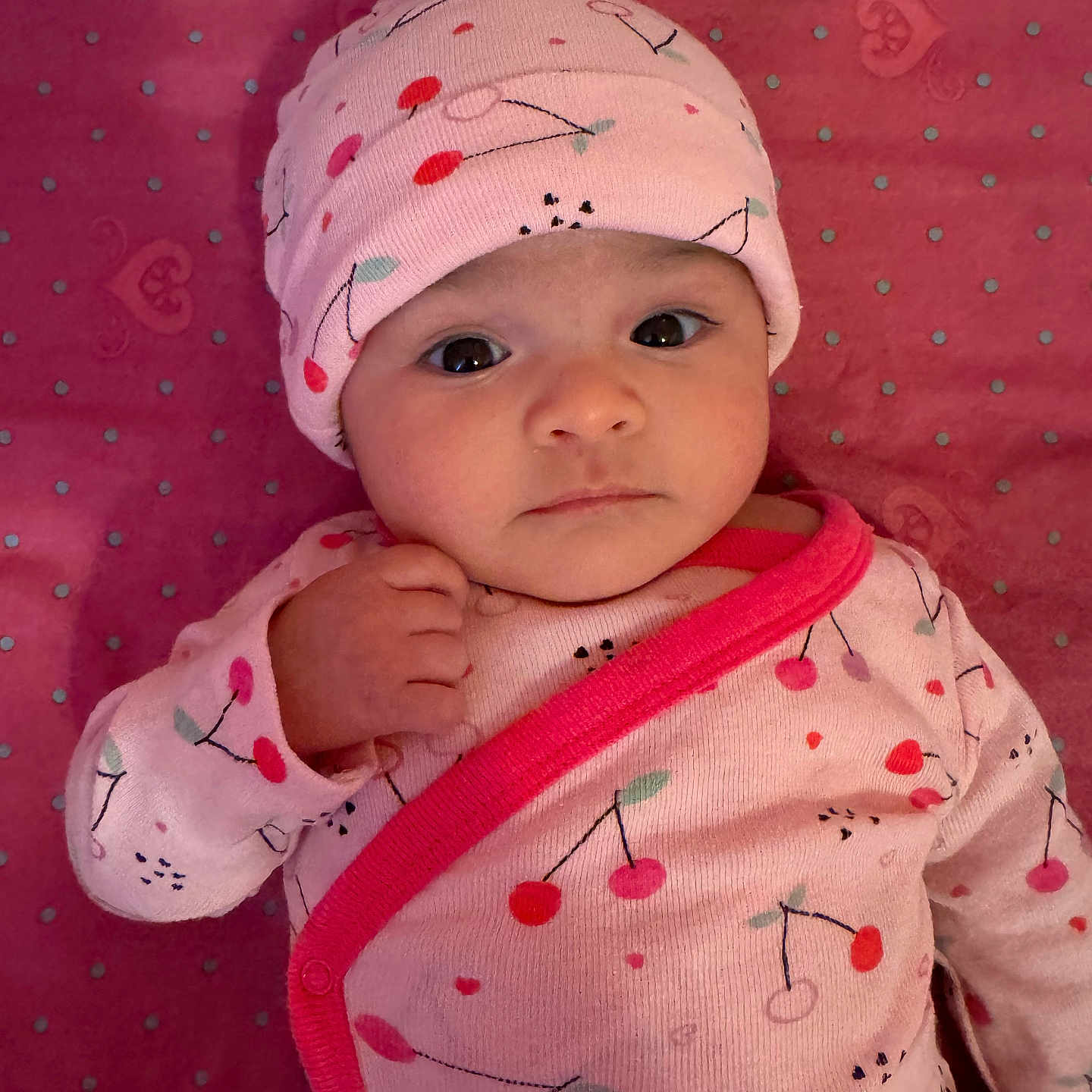 Erica joined the competition — help win amazing prizes! baby, baby_outfit, blanket, cherry_pattern, child, clothing, cute, expression, eyes, fabric, face, hand, hat, infant, lying_down, newborn, pink, polka_dots, portrait, soft_texture