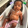baby, bath_time, bathroom, bathtub, child, cleaning, closeup, curly_hair, cute, infant, person, pink_cloth, relaxed, sitting, skin, soap_bubbles, soapy, toddler, water, wet