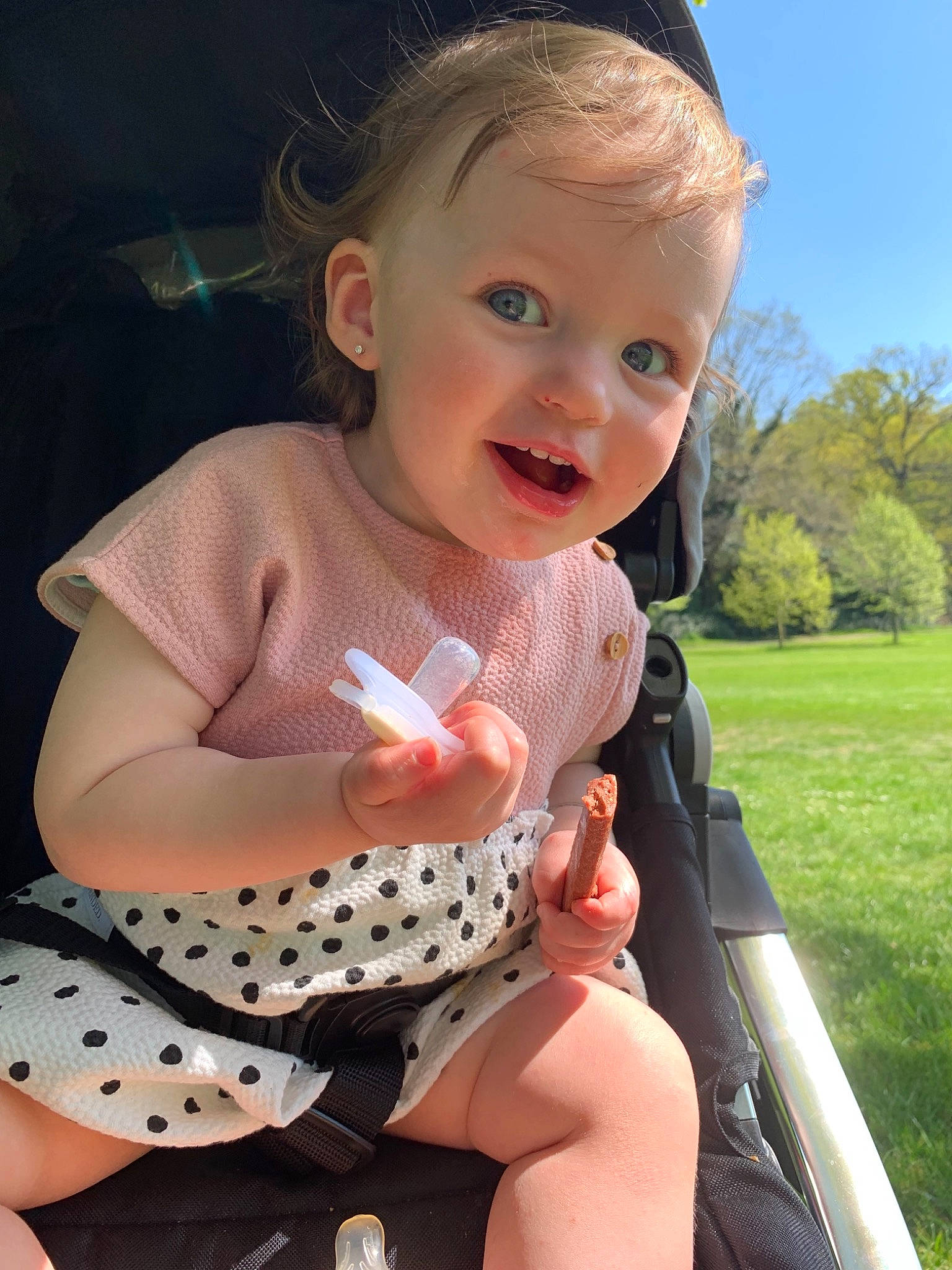 Lilly-mae is registered to the contest to win money with this photo: baby, baby_products, baby_toddler_clothing, child, design, dress, eye, finger, grass, pattern, person, pink, polka_dot, product, sitting, skin, smile, summer, toddler, vacation