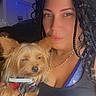 Cookie joined the competition — help win amazing prizes! woman, dog, braided_hair, indoor, portrait, pet, small_dog, casual_clothing, necklace, seated, close_up, transportation, airplane_interior, sparkle_effect, text_overlay, airport, john_f_kennedy, queens_new_york, holding_pet, face