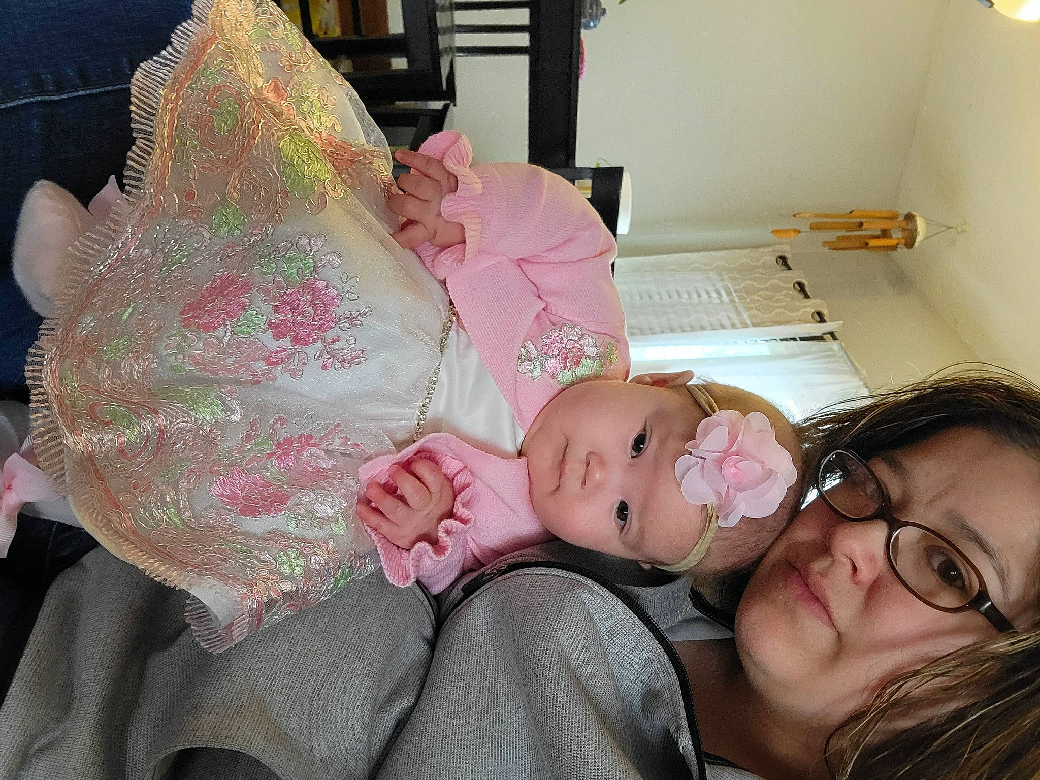 Catalina is registered to the contest to win money with this photo: baby, baby_products, baby_toddler_clothing, cheek, child, comfort, dress, embellishment, eyelash, fashion_accessory, fun, glasses, happy, headwear, leg, person, pink, room, sitting, skin