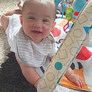 Anastasia joined the competition — help win amazing prizes! baby, smiling, play_mat, toy, carpet, infant, child, happy, indoors, clothing, bib, cute, face, hand, bright, colorful, young, person, soft_toys, floor