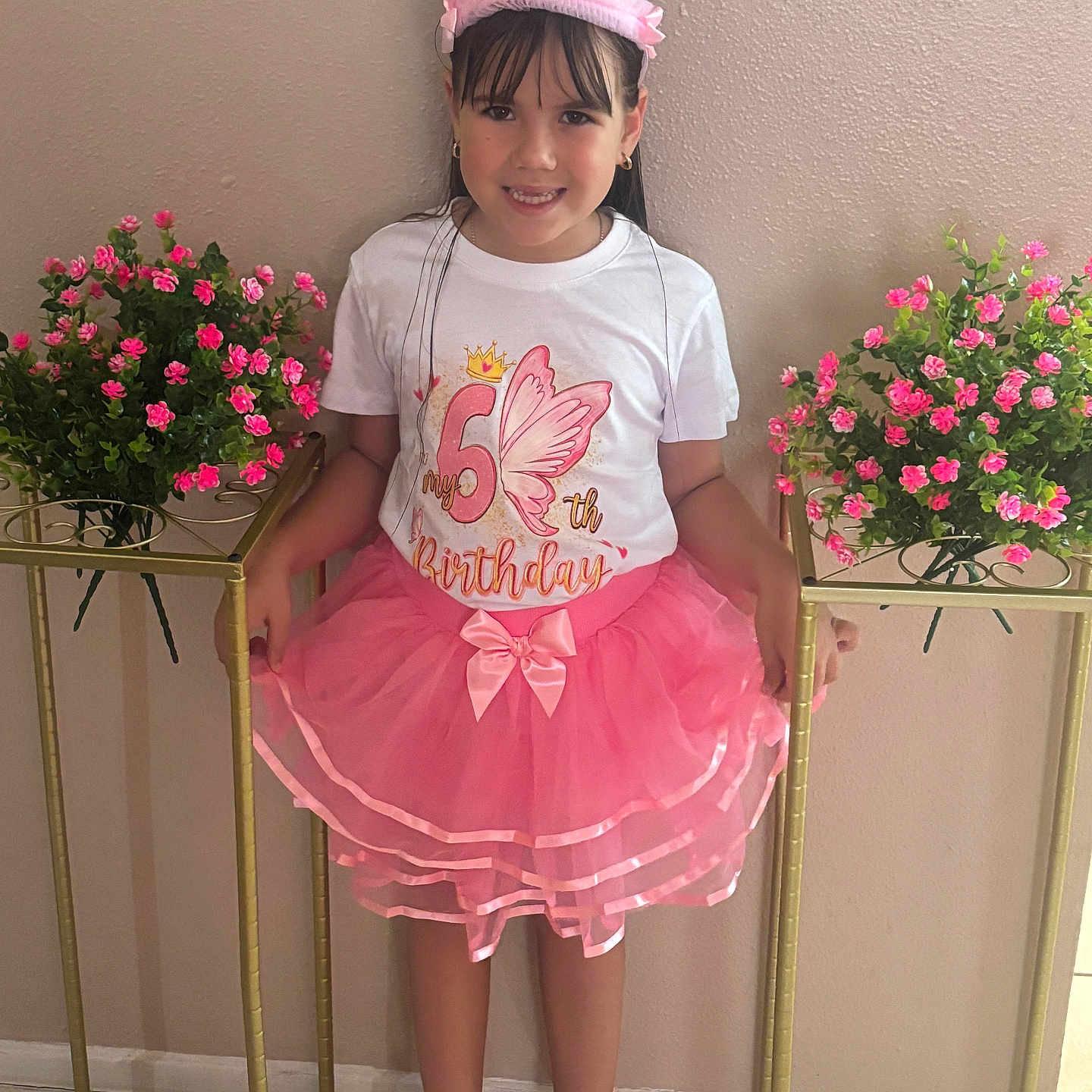 Nathaly is registered to the contest to win money with this photo: birthday, celebration, child, crown, dress, floor, flowers, girl, happy, indoor, person, pink, plant, portrait, pot, shoes, smile, standing, tutu, wall