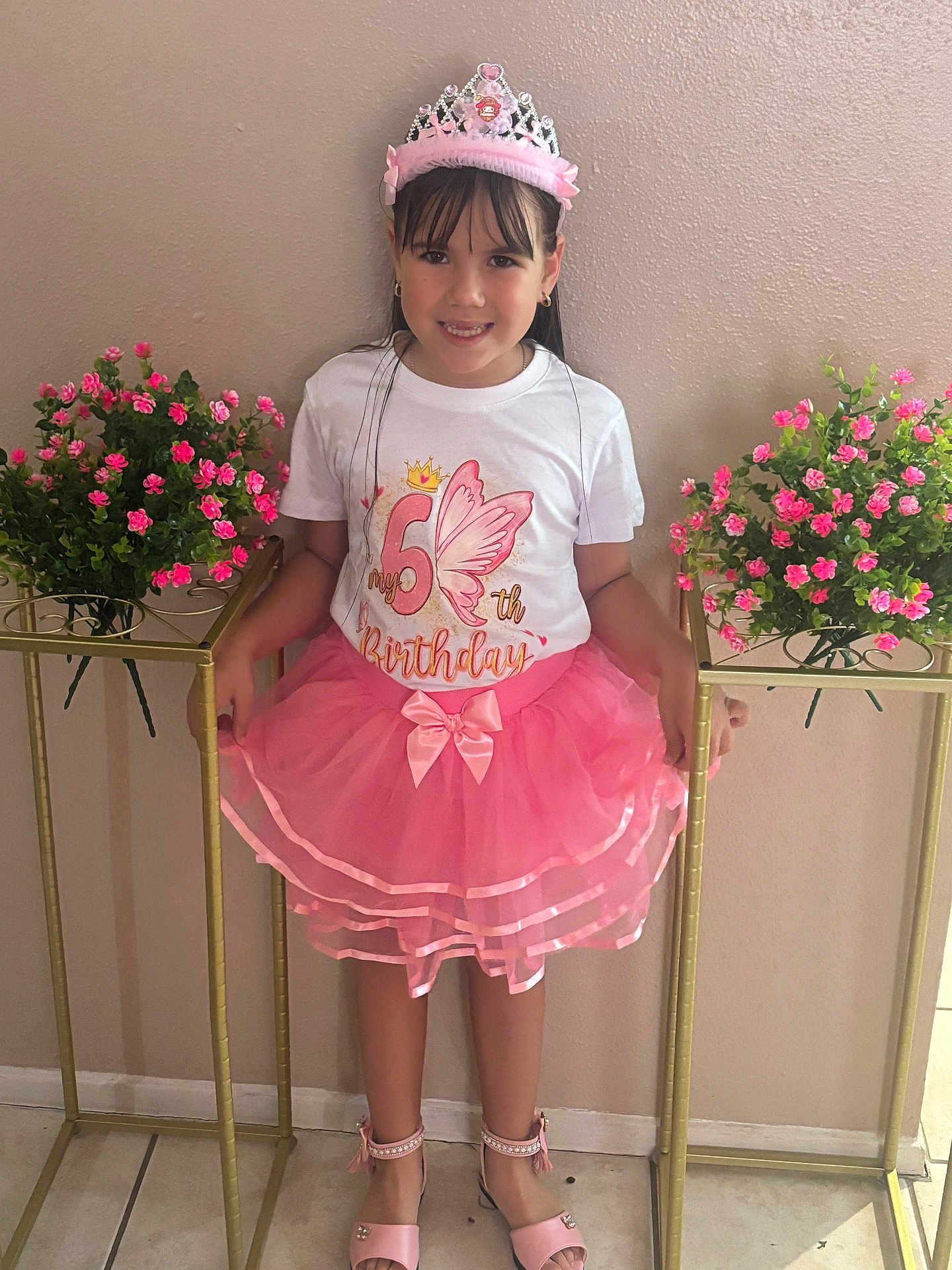 Nathaly is registered to the contest to win money with this photo: child, girl, birthday, tutu, pink, crown, flowers, smile, celebration, dress, standing, indoor, happy, shoes, plant, pot, floor, wall, person, portrait