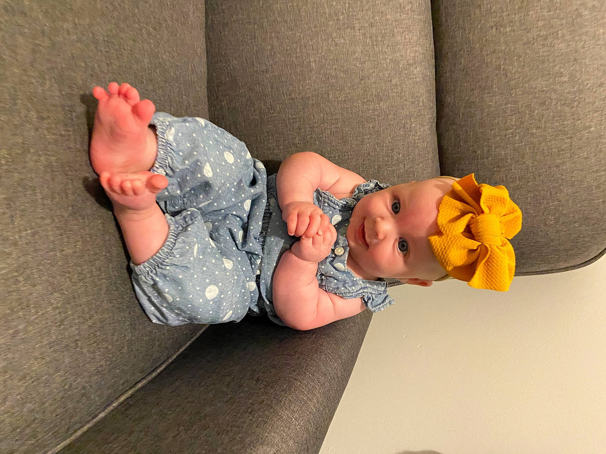 Oaklynn is registered to the contest to win money with this photo: arm, baby, baby_toddler_clothing, child, comfort, finger, foot, glasses, hand, hat, headgear, headwear, human_body, human_leg, knee, leg, person, sleeve, sock, thigh