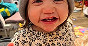 Remi joined the competition — help win amazing prizes! toddler, child, smiling, beanie, hat, indoor, happy, face, person, clothing, pattern, floral, cute, young, portrait, baby, expression, headwear, cheerful, sitting
