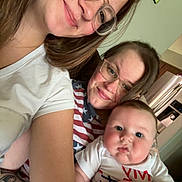Carter joined the competition — help win amazing prizes! baby, woman, glasses, smile, indoor, family, portrait, child, tattoo, casual_clothing, kitchen, refrigerator, photo_frame, couch, holding, face, person, happy, closeup, home