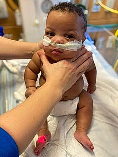 Camden is registered to the contest to win money with this photo: baby, baby_toddler_clothing, cheek, ear, eye, eyebrow, eyelash, face, finger, gesture, hand, happy, head, iris, mouth, nose, person, skin, smile, thumb