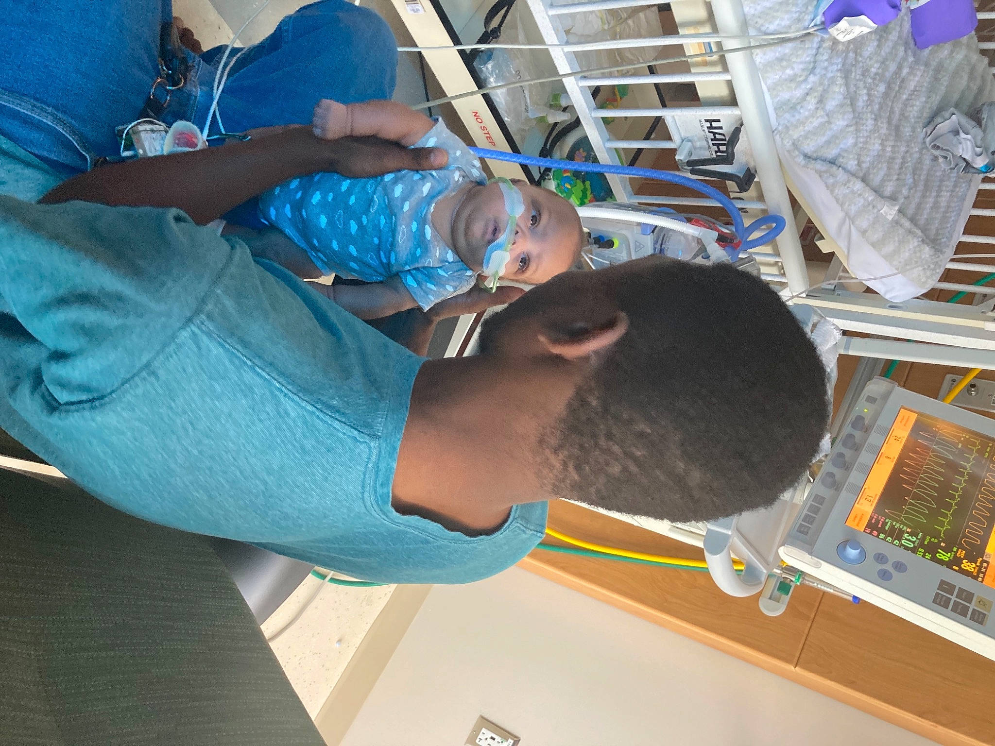 Camden is registered to the contest to win money with this photo: blue, child, comfort, denim, display_device, elbow, electric_blue, electrical_wiring, electronic_engineering, engineering, fun, hat, human_leg, jeans, leisure, machine, person, room, t_shirt, thigh