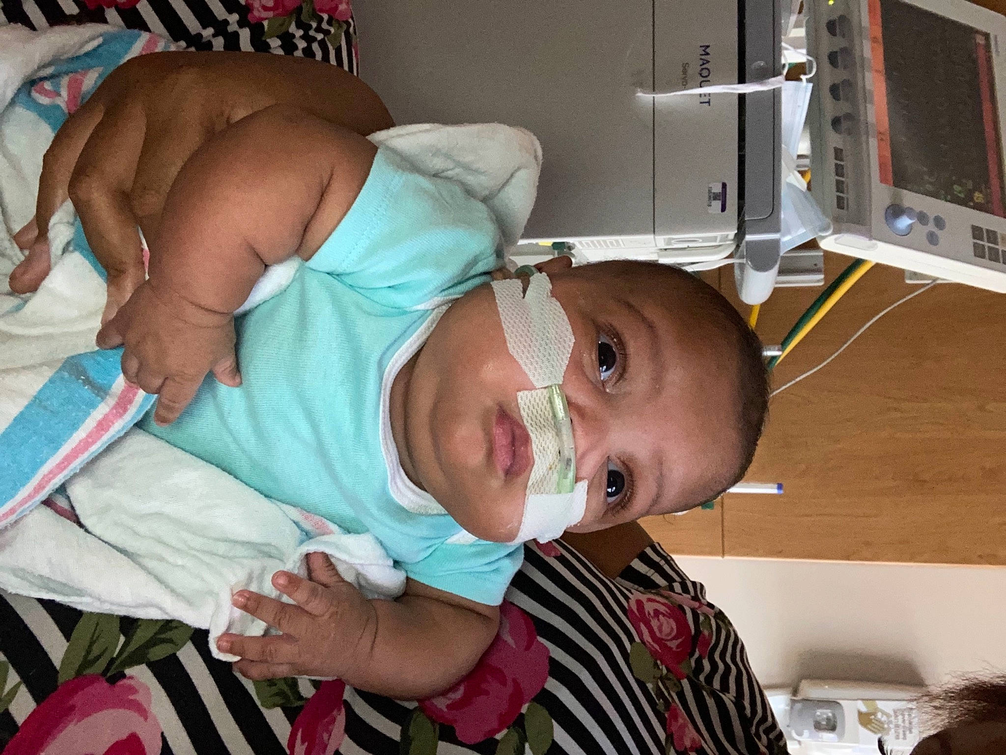 Camden is registered to the contest to win money with this photo: baby, baby_products, baby_toddler_clothing, child, comfort, elbow, event, hat, health_care, hospital, machine, medical, medical_procedure, mouth, organ, patient, person, room, service, toddler