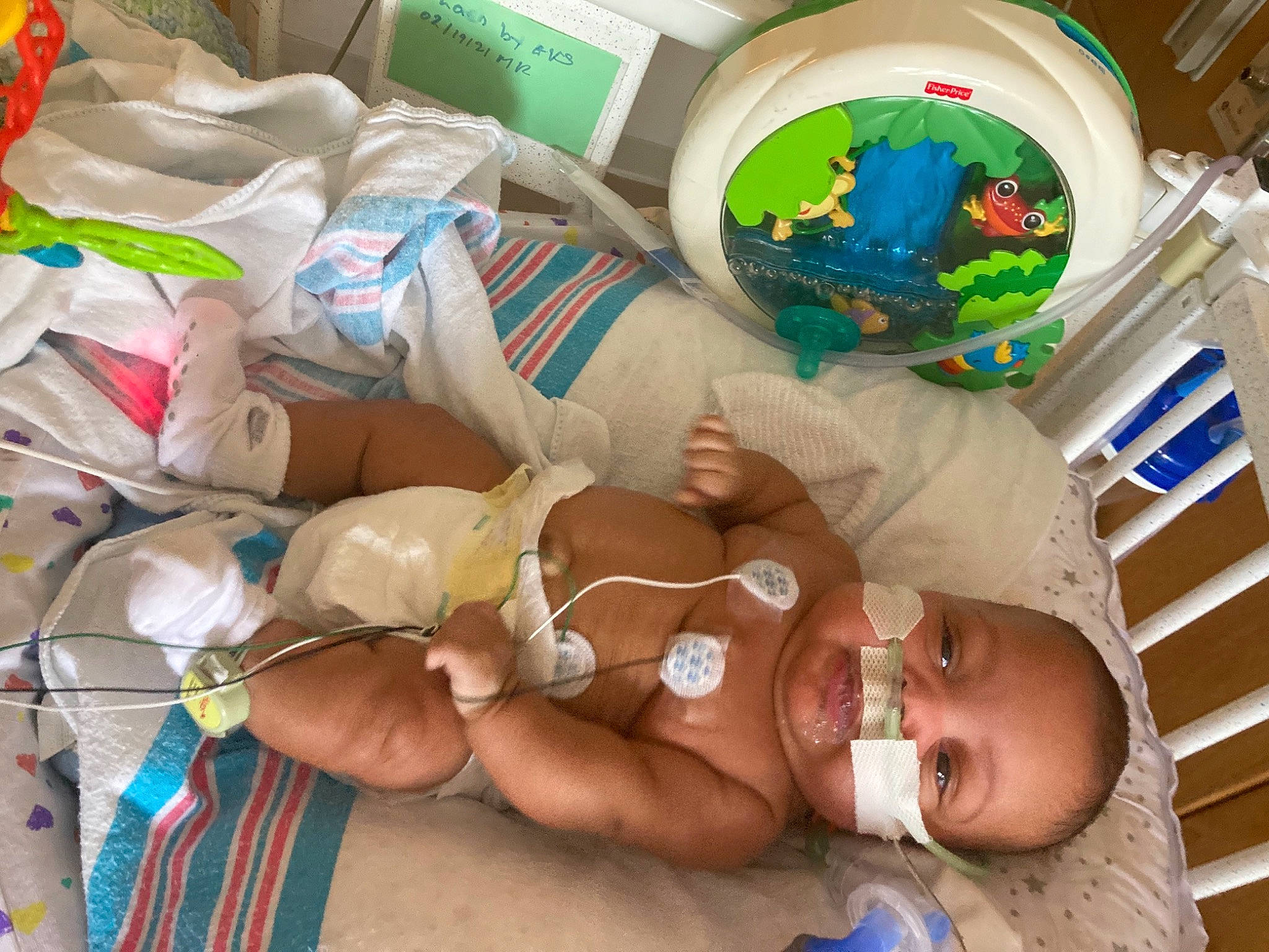 Camden joined the competition — help win amazing prizes! abdomen, baby, baby_products, baby_toddler_clothing, barechested, blue, chest, child, comfort, diaper, event, hat, infant_bed, linens, packing_materials, person, plastic, plastic_bag, room, textile