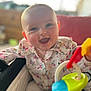 Romane participe au concours pour gagner de l'argent avec cette photo : baby, child, smiling, toy, colorful_toy, floral_shirt, happy, indoors, portrait, sitting, cute, infant, playful, face, person, young_child, bright, warm_light, closeup, soft_focus