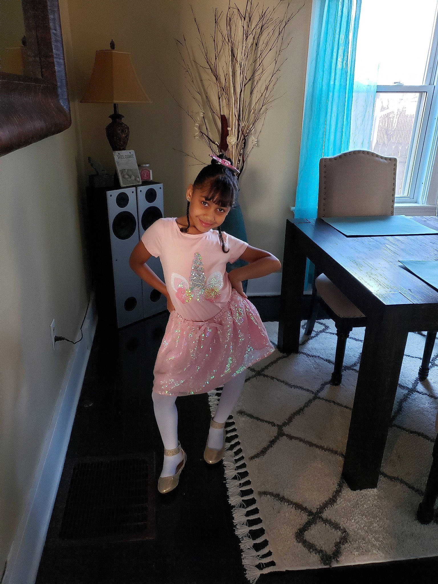 Audrianna is registered to the contest to win money with this photo: child, costume, dress, floor, flooring, furniture, house, joy, leg, person, pink, room, table, toddler, vacation