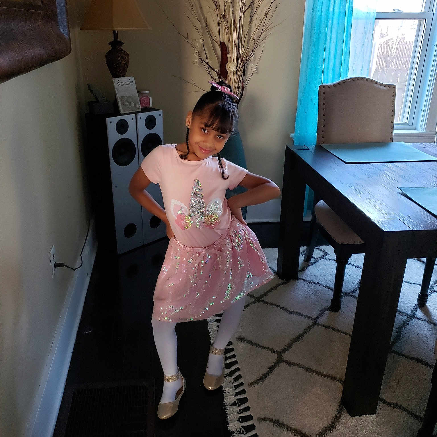 Audrianna is registered to the contest to win money with this photo: child, costume, dress, floor, flooring, furniture, house, joy, leg, person, pink, room, table, toddler, vacation