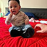 Emerie joined the competition — help win amazing prizes! baby, bed, bedroom, casual, child, clothing, curly_hair, cute, footwear, hand, headband, indoor, jeans, person, pillow, playful, red_bedspread, shirt, sitting, smiling
