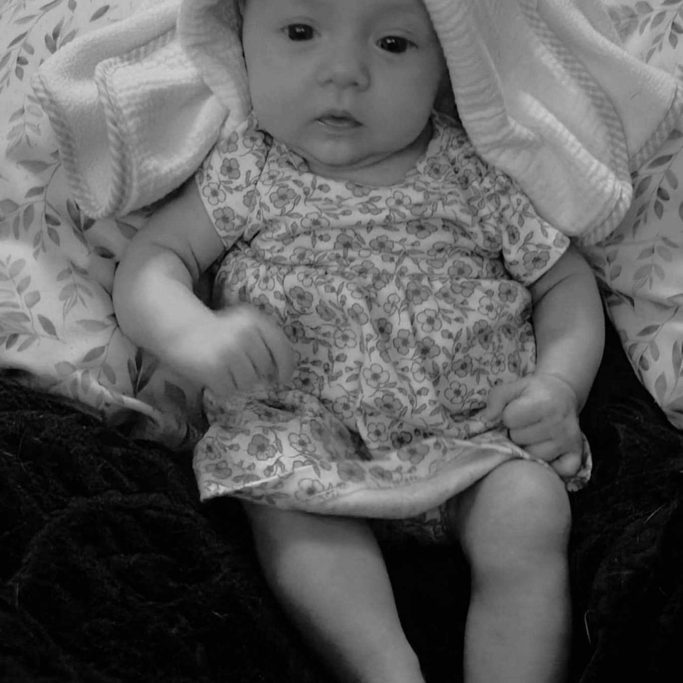 Sommar joined the competition — help win amazing prizes! arms, baby, blanket, child, closeup, clothing, comfort, curious, cute, dress, face, indoors, infant, legs, monochrome, pattern, portrait, sitting, soft_texture, towel