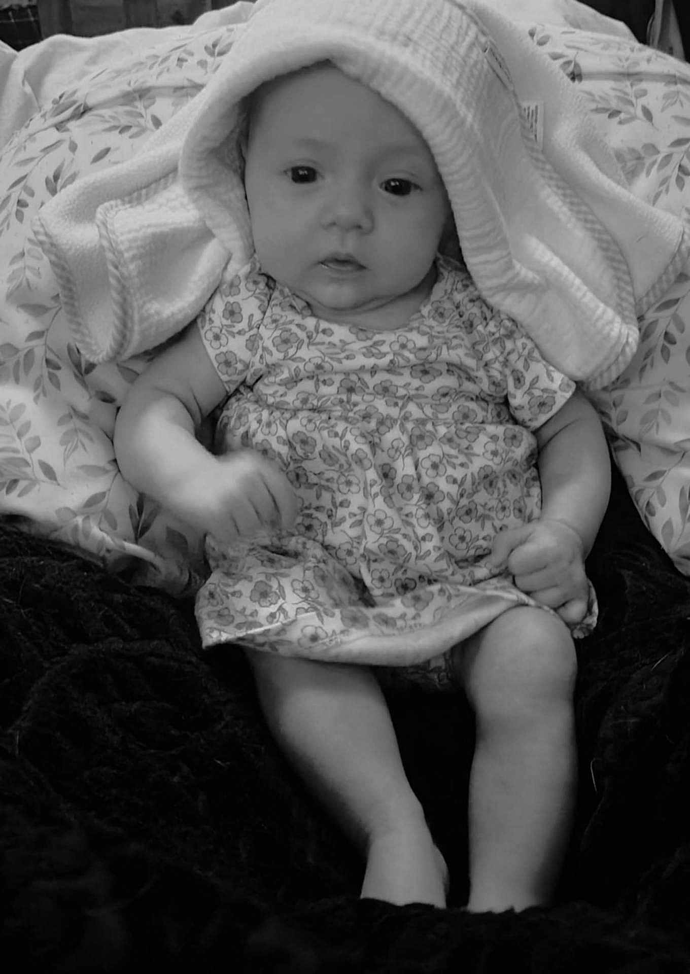 Sommar joined the competition — help win amazing prizes! baby, infant, towel, blanket, dress, pattern, face, legs, arms, sitting, curious, soft_texture, monochrome, portrait, closeup, indoors, child, cute, clothing, comfort