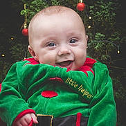Jacob joined the competition — help win amazing prizes! baby, child, smiling, christmas, holiday, green_clothing, festive, ornaments, christmas_tree, happy, cute, portrait, seasonal, celebration, toddler, red, decoration, face, joy, outdoor