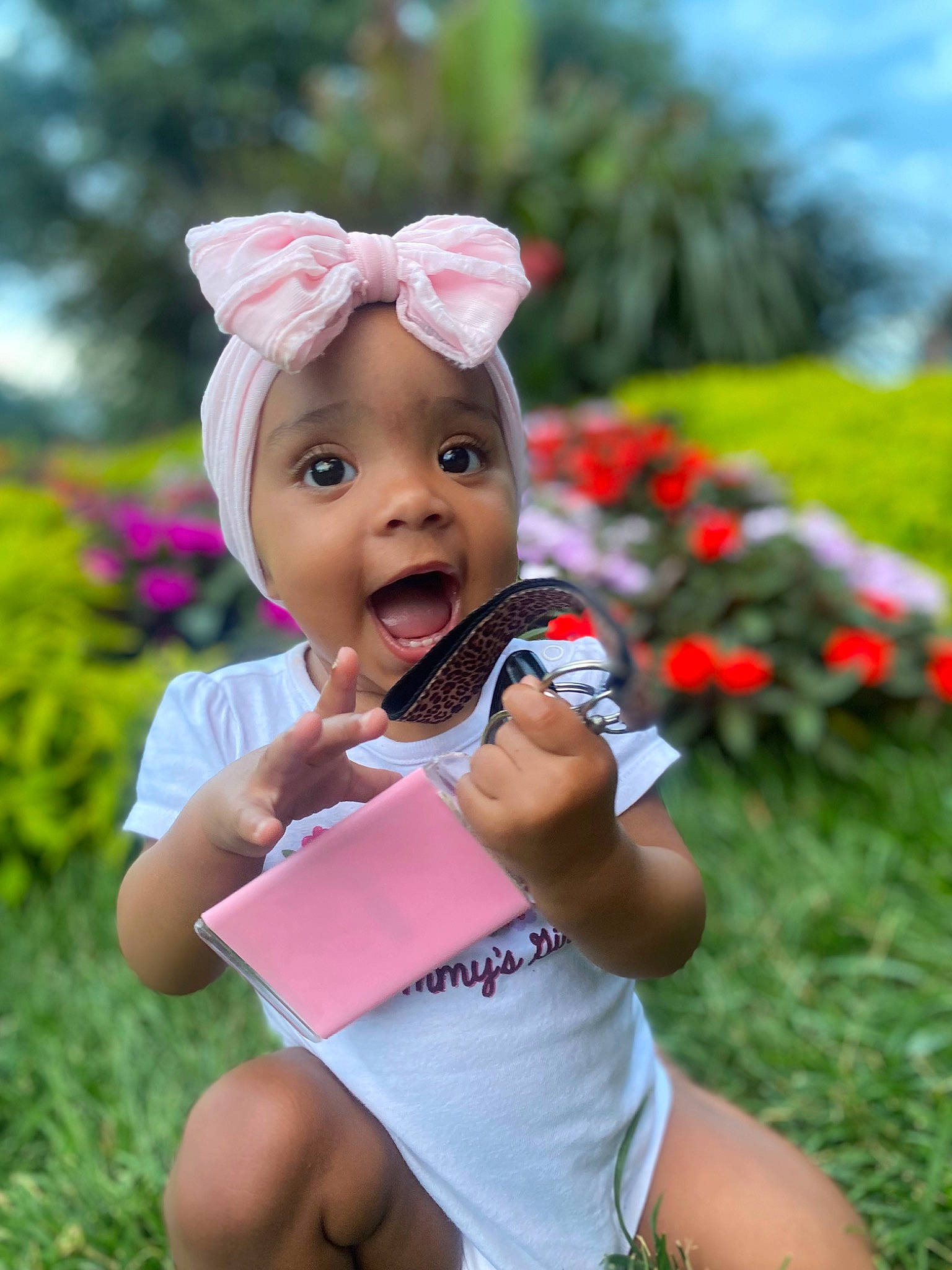 Vailynn is registered to the contest to win money with this photo: baby_toddler_clothing, cap, child, finger, fun, gesture, grass, happy, hat, leisure, magenta, people_in_nature, person, pink, plant, recreation, skin, sky, smile, summer