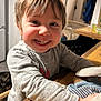 Marceau a rejoint le concours — aidez-le/la à gagner de superbes lots ! background, child, clothing, coats, cute, face, furniture, hair, happy, home, indoor, kitchen, long_sleeve_shirt, person, portrait, smiling, table, toddler, toy, wood