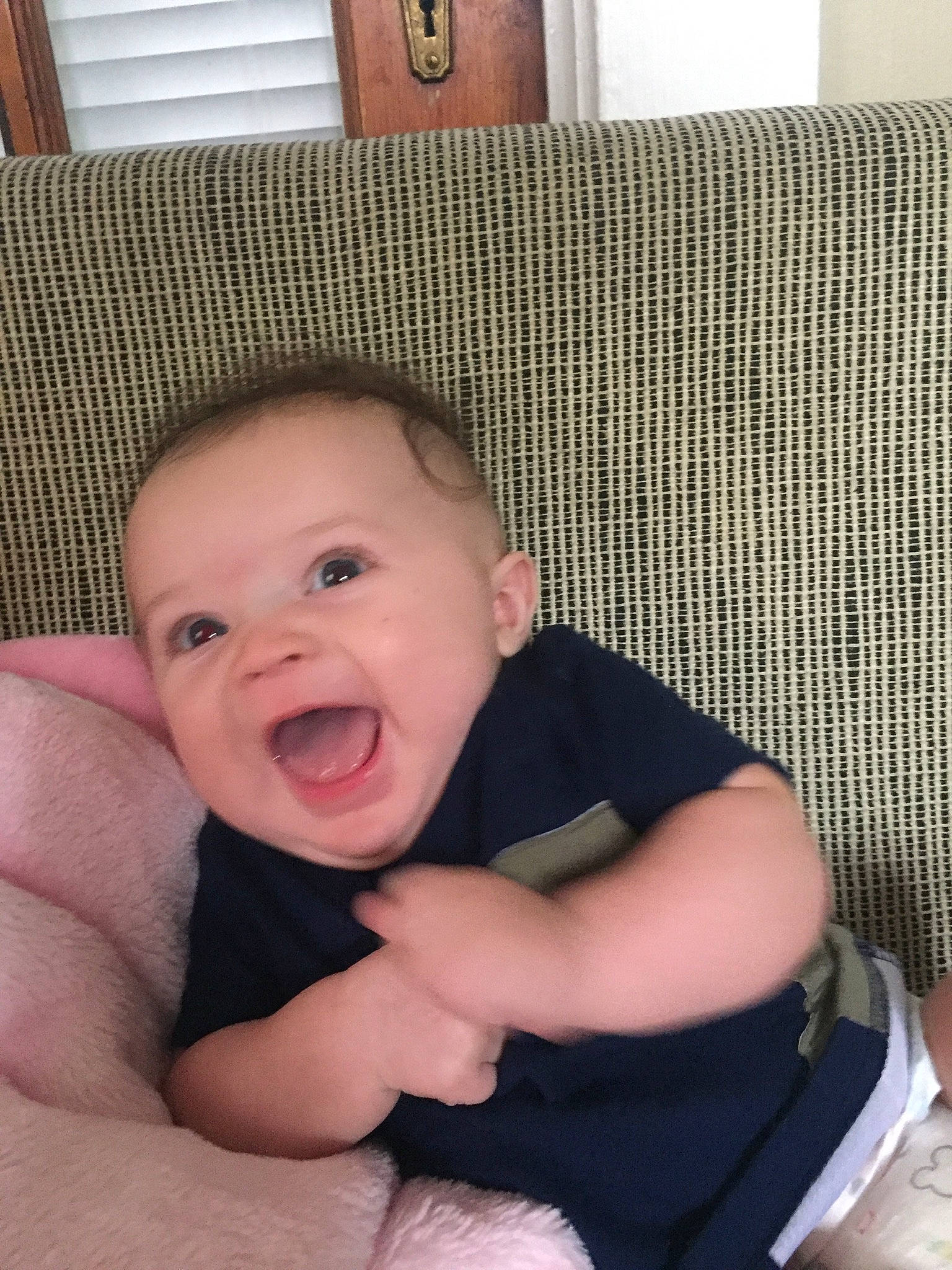 Kj is registered to the contest to win money with this photo: arm, baby, cheek, child, chin, electronic_device, eye, face, facial_expression, finger, hand, head, leg, mouth, nose, person, product, sitting, skin, smile