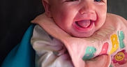 Davina joined the competition — help win amazing prizes! baby, smiling, infant, blue_seat, bib, clothing, happy, portrait, face, child, cute, indoor, seated, rosy_cheeks, heart_pattern, soft_lighting, pink_bib, colorful_letters, joyful, closeup