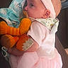 baby, blanket, child, clothing, couch, cute, fabric, headband, indoors, infant, newborn, orange_toy, person, pink_outfit, plush_toy, portrait, resting, side_view, soft_toys, tutu